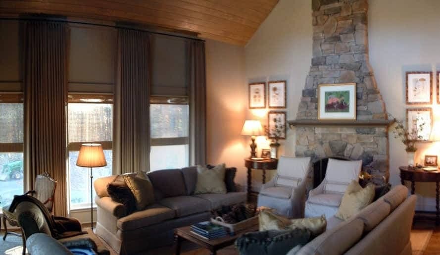 Living room with stone fireplace in Meadow Creek custom home
