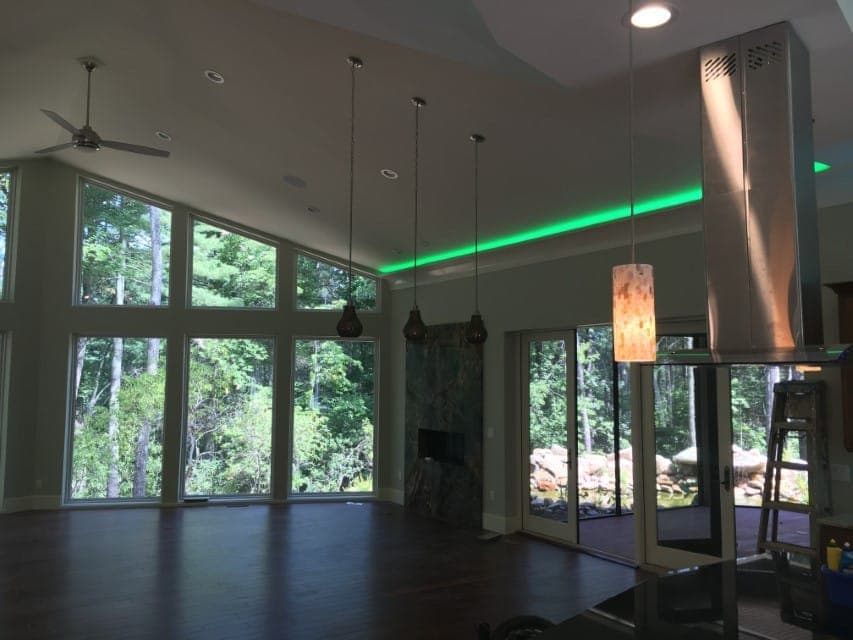 Living room with floor-to-ceiling windows and forest view